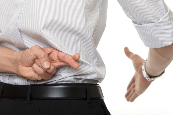 crossed fingers at handshake as a symbol of breach of contract